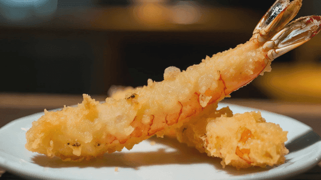 Crispy shrimp tempura served on white plate