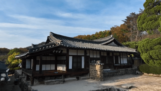 Traditional Korean house with autumn trees