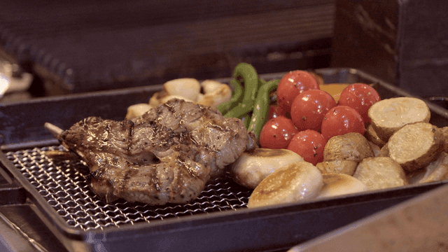 Grilled lamb rib steak and vegetables on platter