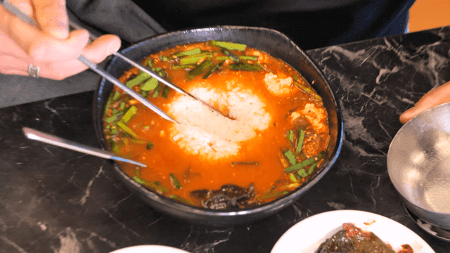 Adding rice to spicy sundubu jjambbong