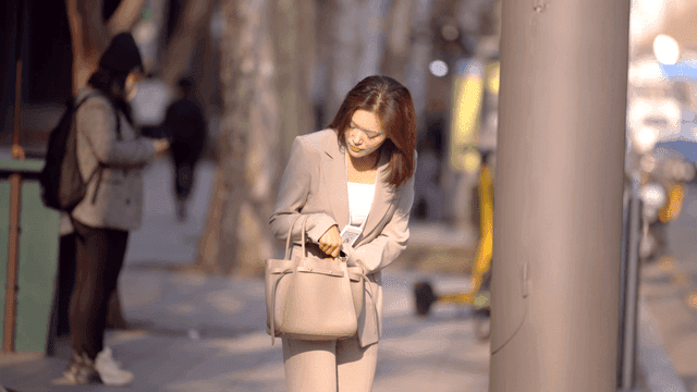 Working woman checking her bag on city street