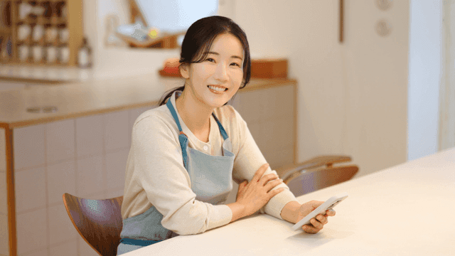 Woman smiling while holding a smartphone