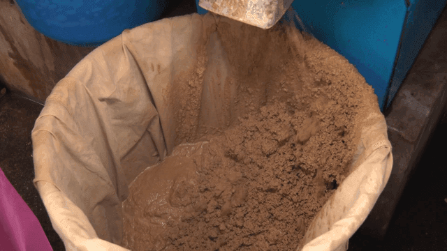 Ground acorns coming out of a machine