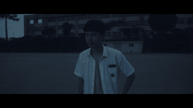 Student crying sadly in schoolyard at dark night