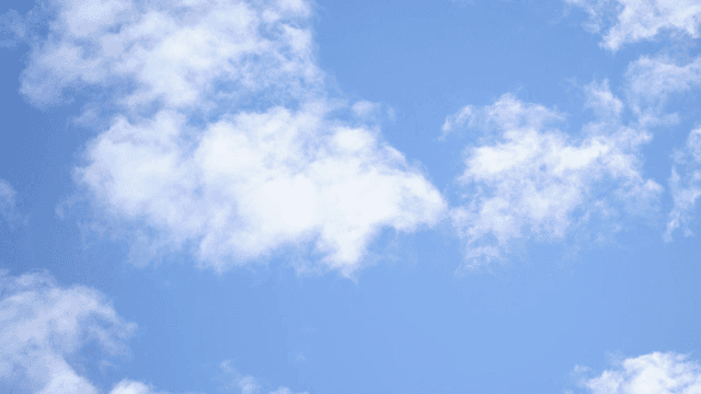 Clear blue sky with fluffy white clouds