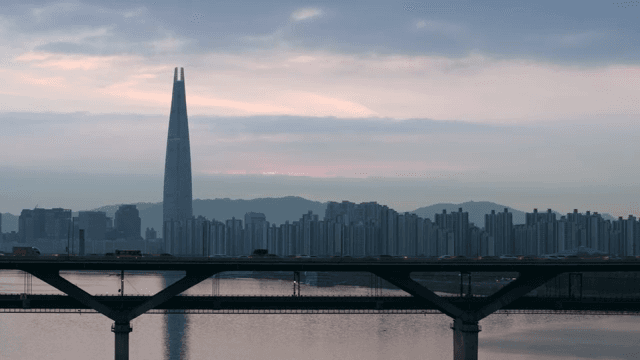 City skyline with a tall tower at dusk