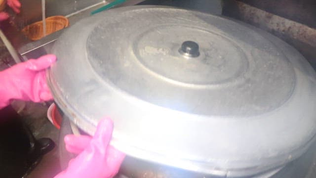 Pig's feet cooked in a large cauldron