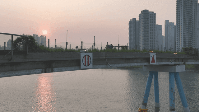 Sunset over a bridge with city skyline