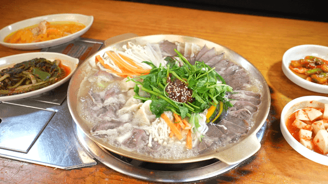 Hot stew and side dishes boiling on table