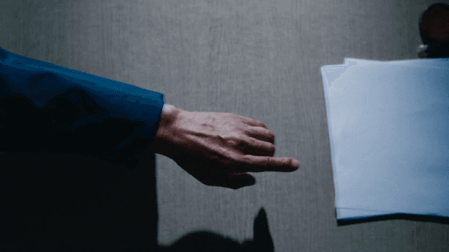Prisoner reaching for documents