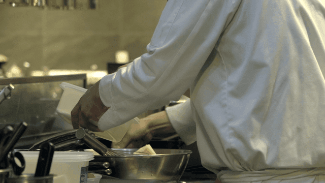 Back view of chef preparing ingredients in kitchen