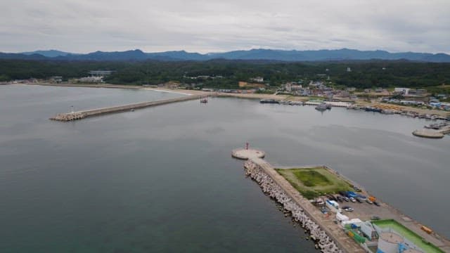 긴 부두와 잔잔한 바다가 있는 해안 마을