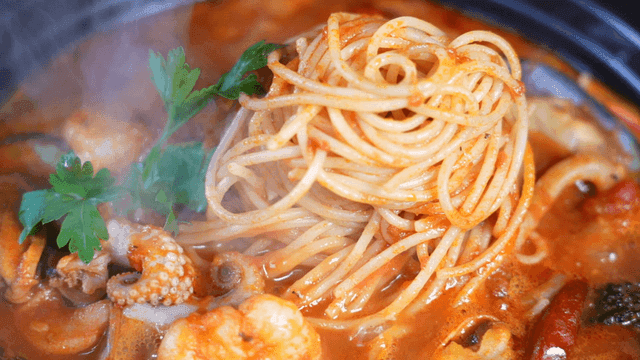 Steaming seafood pasta in a rich broth