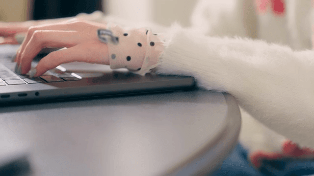 Person typing on a laptop indoors