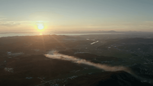 Sunset over a vast landscape with mountains