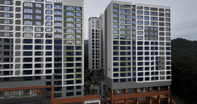 Modern apartment buildings with forest