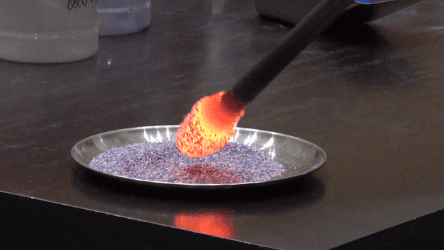 Glass imprinted on tray of purple granules