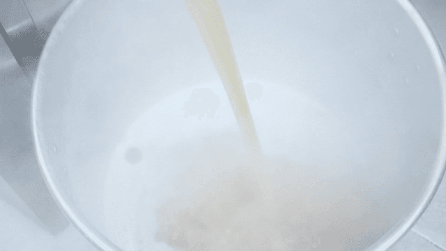 Steaming broth being poured into pot