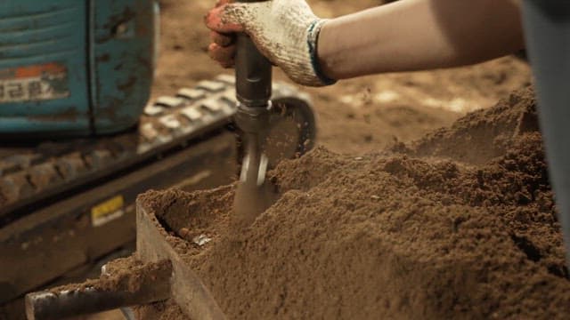 Scene of soil being compacted with a machine