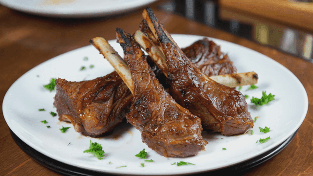 Grilled lamb chops on a white plate
