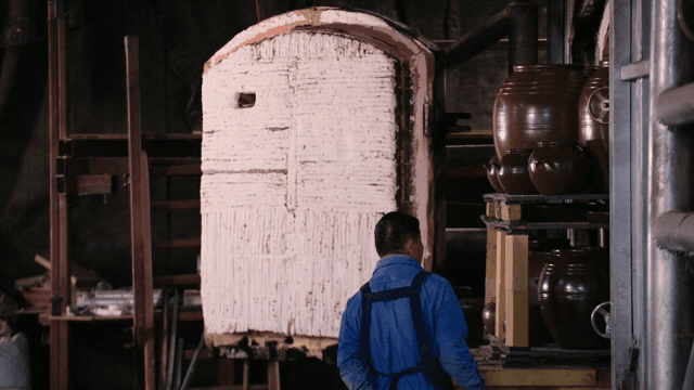 가지런히 놓인 전통 항아리를 점검하는 작업자