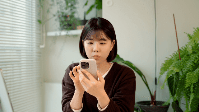 Young woman using smartphone at home
