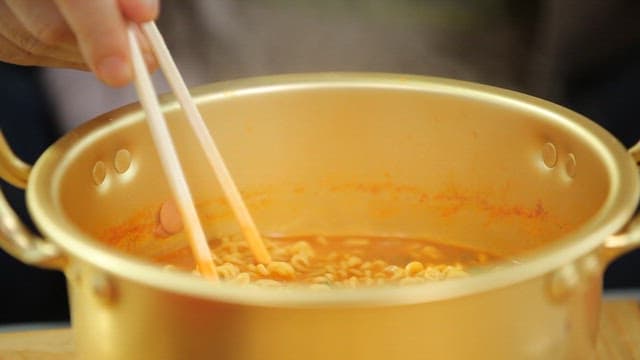 Chopstickful of warm ramen from a pot of sheep