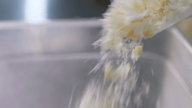 Breadcrumbs falling into container