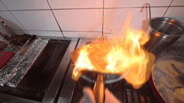 Stir-frying vegetables with flames