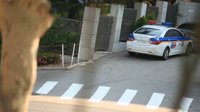 Police Car Parked on a Urban Road