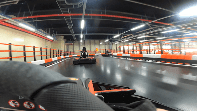 Indoor go-kart racing track with drivers