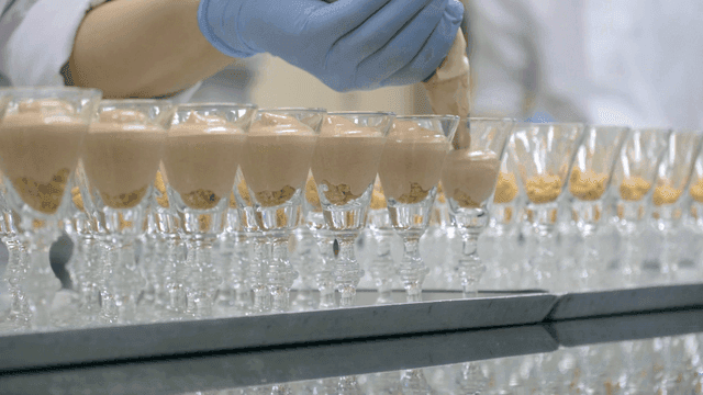 Cream poured into cups displayed in kitchen