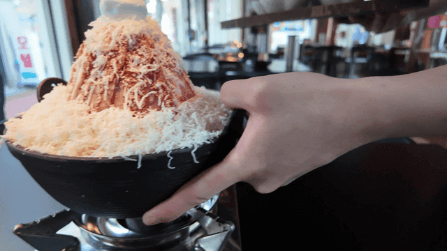 Cheese mala hot pot served over gas burner