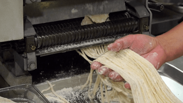 Kalguksu noodles being made with a machine