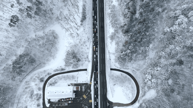 겨울에 눈 덮인 도로와 가드레일에 박혀있는 트럭