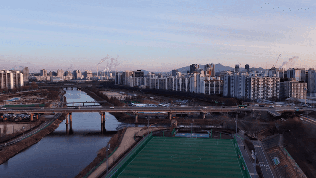 Cityscape with river and soccer field