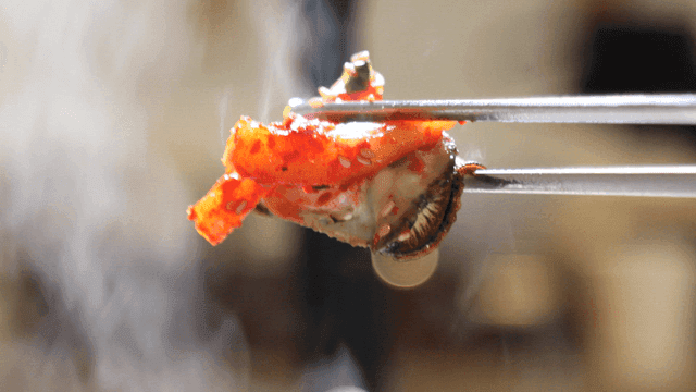 Steamed oyster with spicy kimchi topping