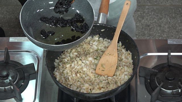 볶은 양파와 고기가 있는 프라이팬에 춘장을 섞는 모습