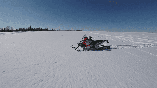 Snowmobiles on vast snowfield