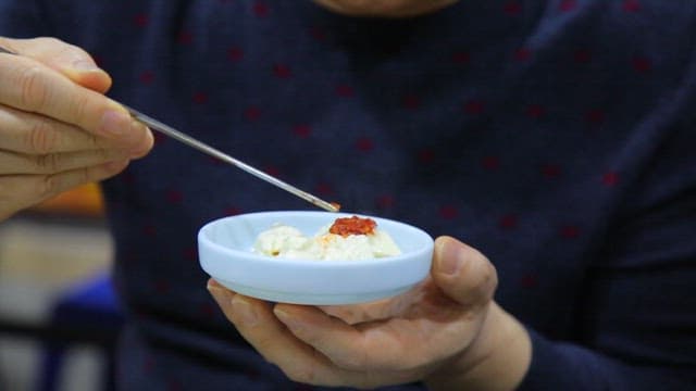 젓가락으로 양념을 곁들여 먹는 순두부