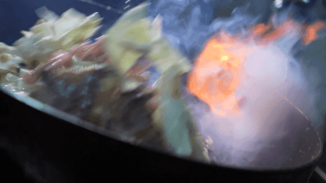 Stir-frying vegetables with flames