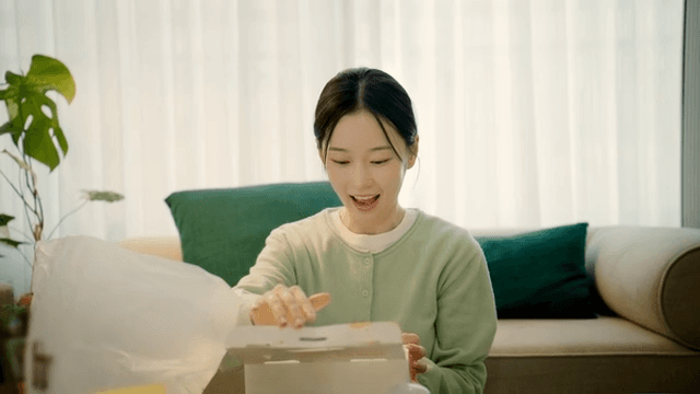 Woman happily opens box of chicken