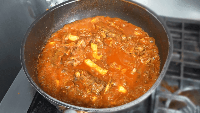 Spicy braised crunchy pork ribs boiling in pot