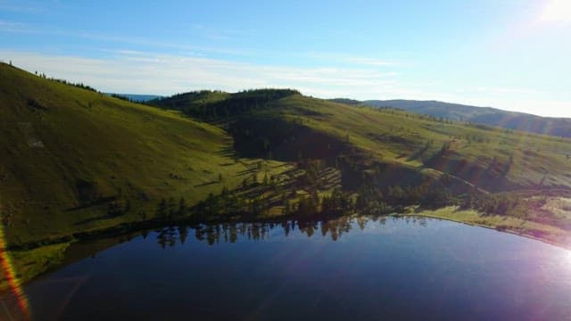 Green hills and a tranquil lake