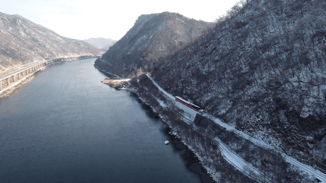 Train running through snow-covered mountain