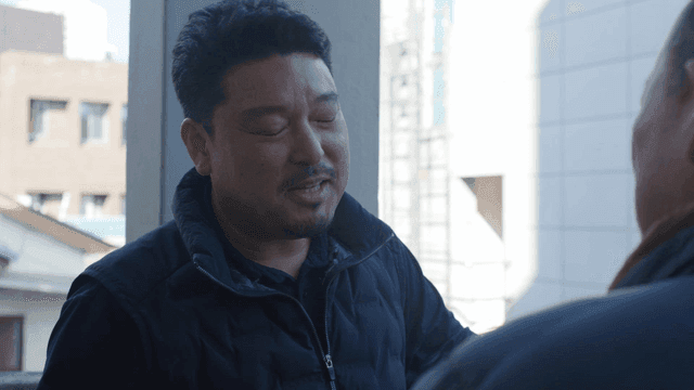 Two men having a conversation outdoors