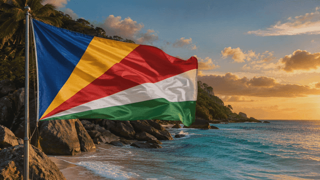 Seychelles flags fluttering at sunset on beach