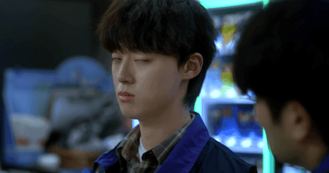 Young man glaring at man speaking in store