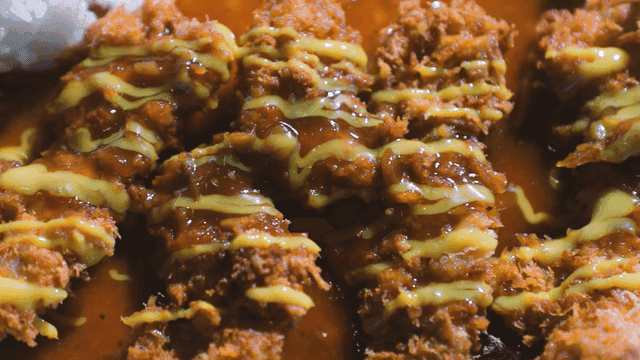 Crispy pork cutlet served with sauce and rice