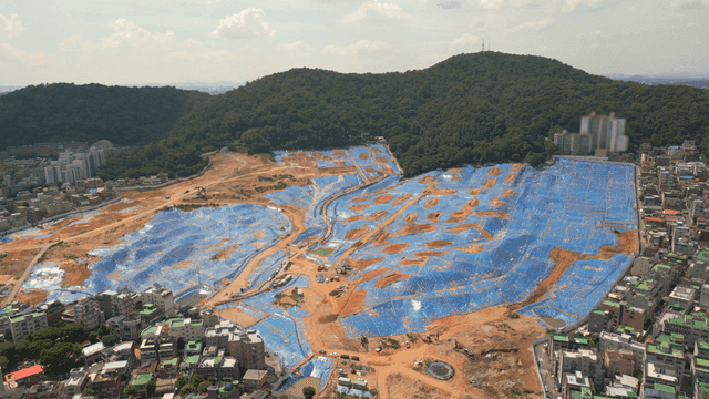 Construction site covered with blue tarpaulin